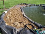 Rinsing pea gravel, flushing out the far end onto the gras.JPG