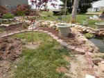 Flower beds filled with dirt and edging stones in place.JPG