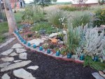 Insulators lining flower bed.JPG