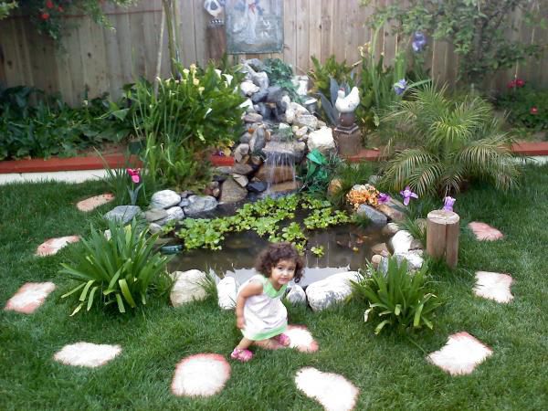 Little niece in front of finished pond